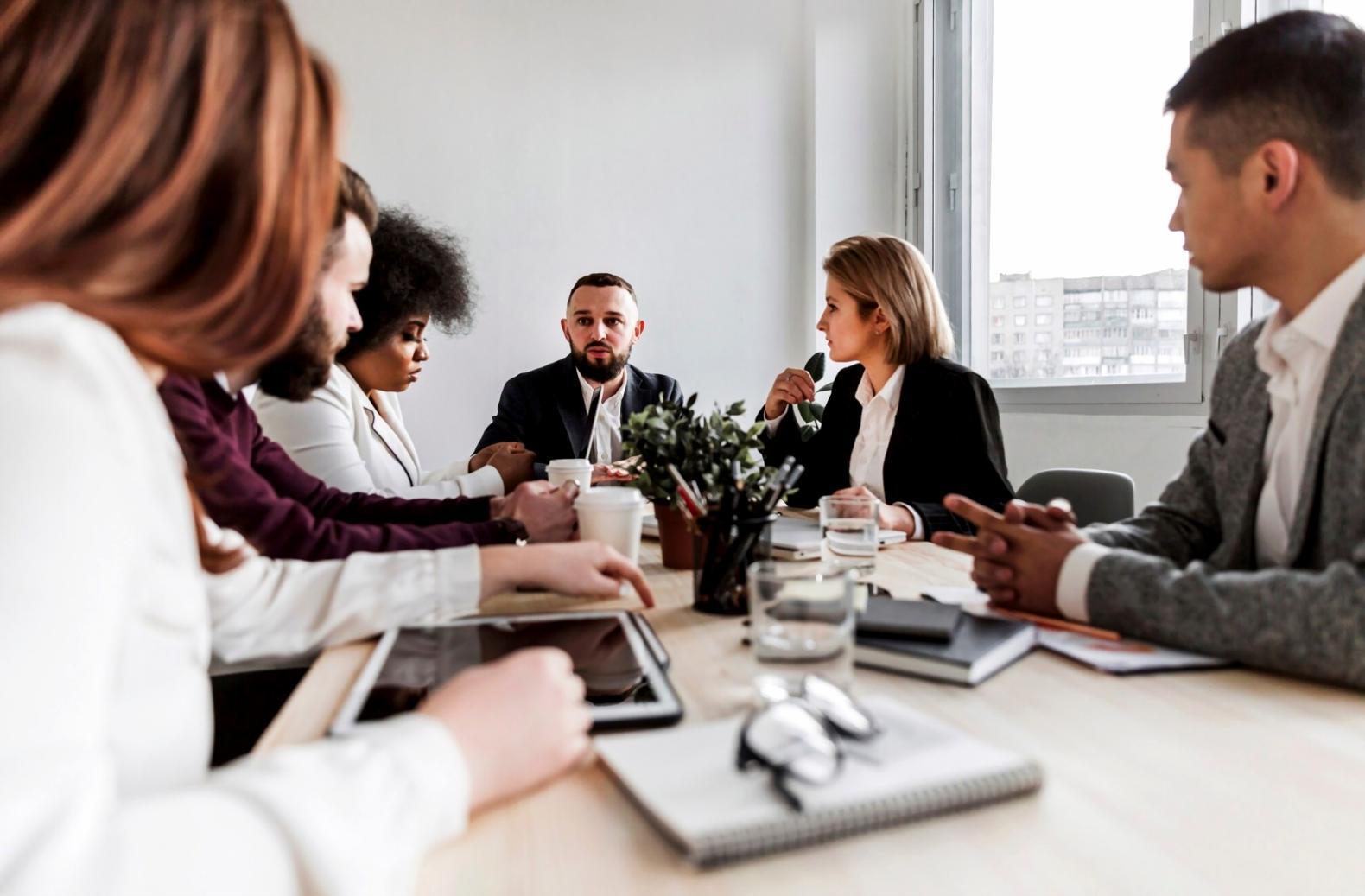 Students collaborating on budget analysis projects in modern learning environment